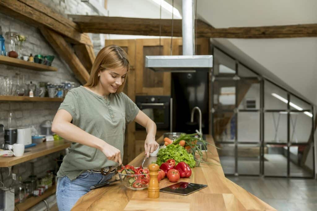 Young woman in Calgary preparing a meal from the Coaching Program in NutriPOM's Holistic Nutrition Programs.